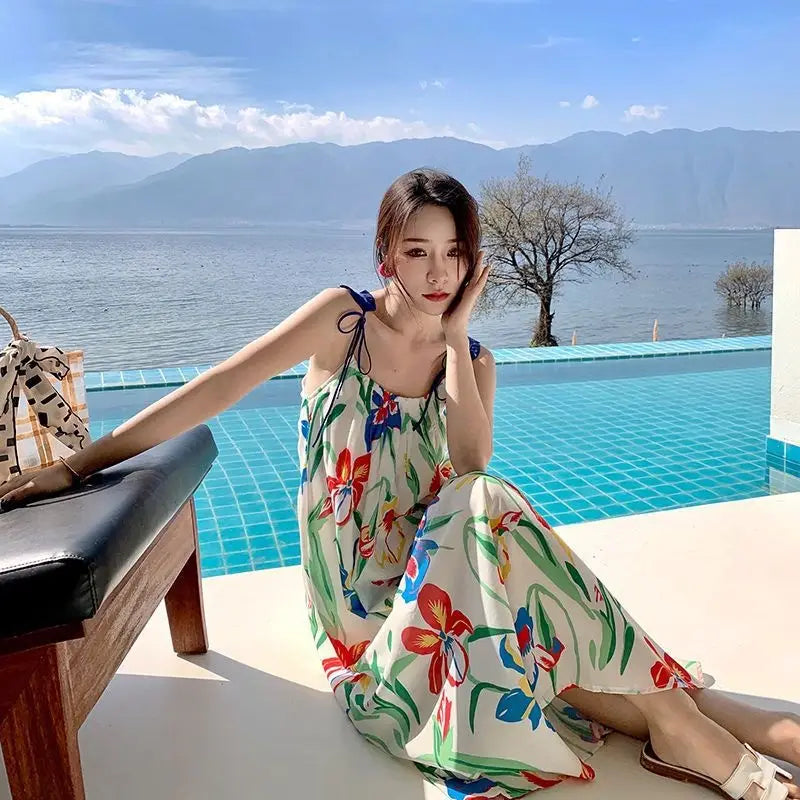 An off-white floral mesh maxi dress with vibrant red blue and green floral patterns featuring a retro slip silhouette.