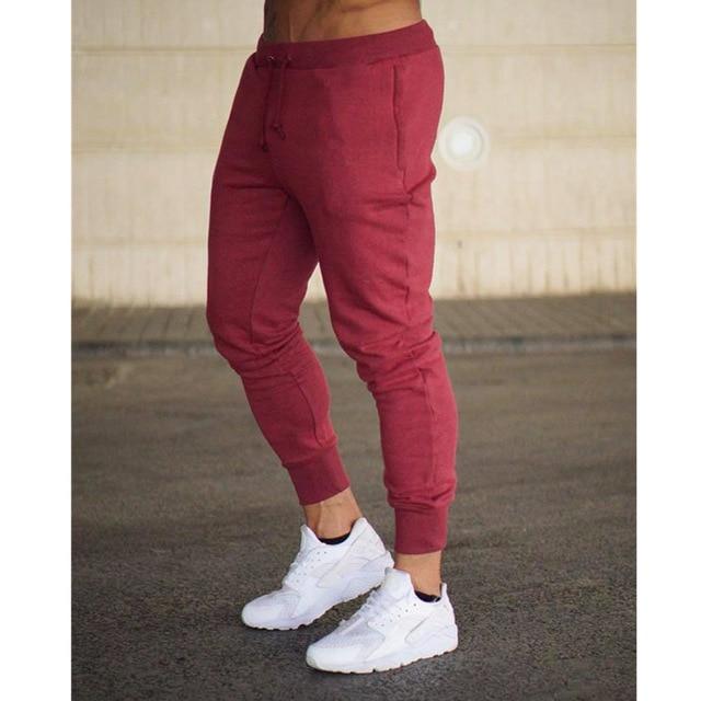 Men’s casual slim fit jogger pants in maroon with elastic waistband and ribbed cuffs for comfortable everyday wear.