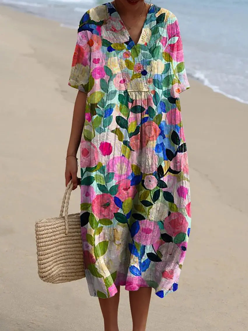 A vibrant floral v-neck short sleeve maxi dress featuring lightweight fabric in shades of pink, blue, green, and white.