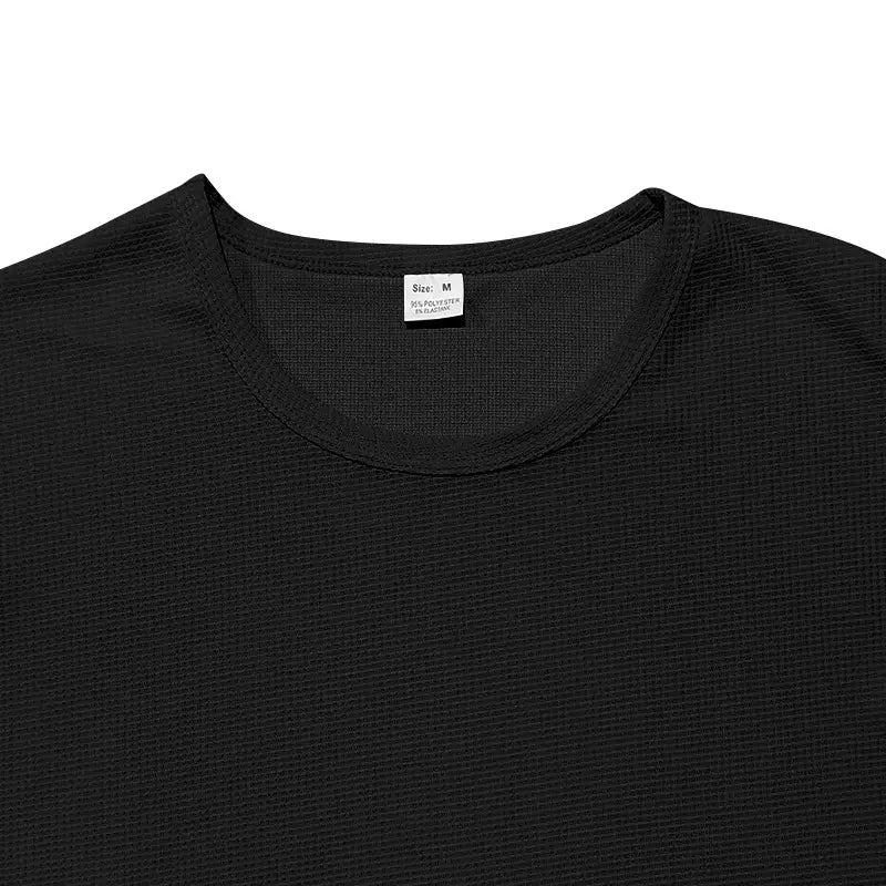 Men’s long sleeve waffle knit thermal pullover in black textured cotton polyester blend with crew neck and size medium label.