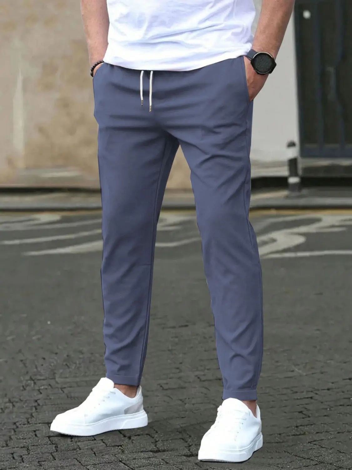 Dark gray slim fit tapered jogger pants with white drawstrings and a tapered leg design ideal for casual and athletic wear.