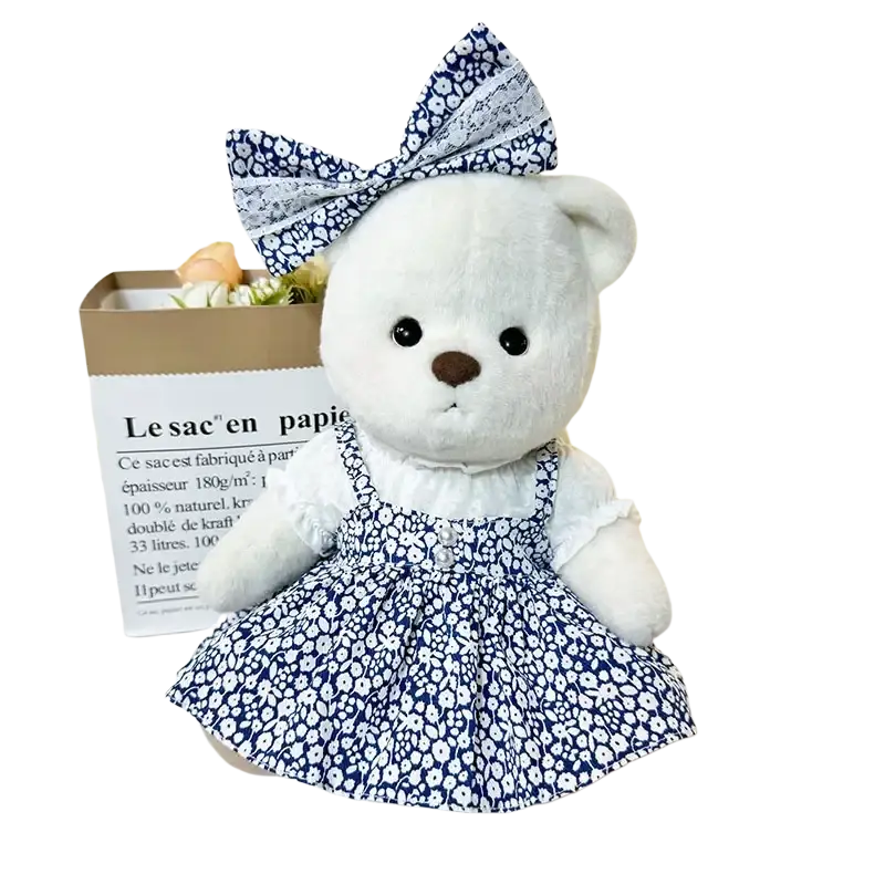 A 30cm nude bear plush dressed in navy blue and white floral doll clothes with lace trim and matching bow manual measurement