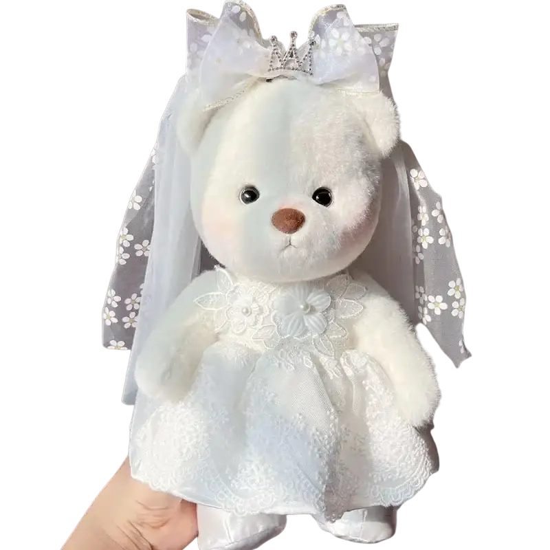 A 30cm nude bear plush dressed in a white lace wedding gown with veil and floral bow for elegant display