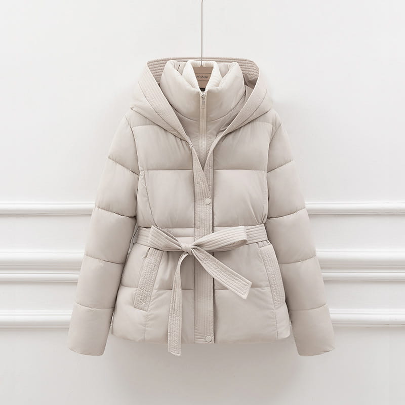 Beige quilted hooded winter puffer coat for women with a matching belt tied at the waist.