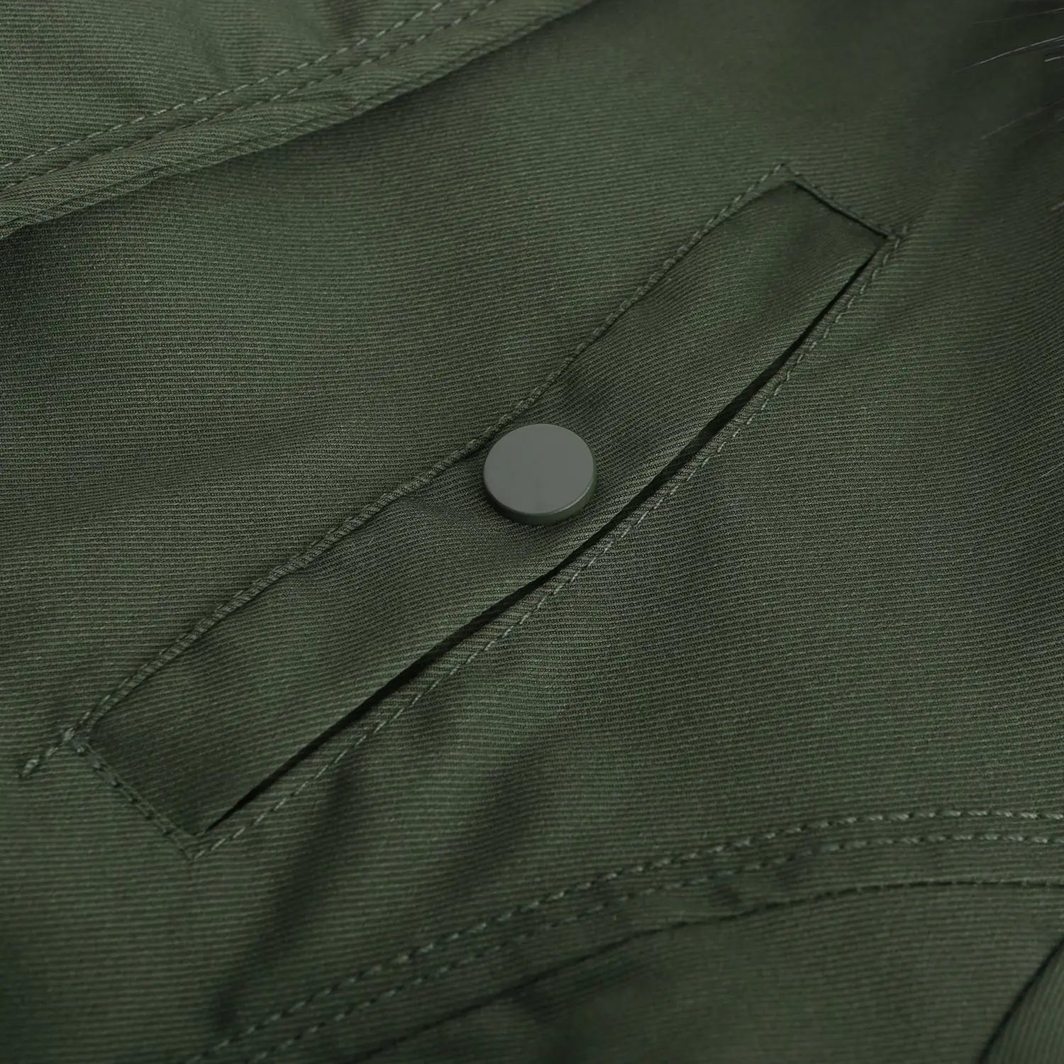 Dark green reversible fur collar quilted parka made of tactical fabric with a subtle woven texture reinforced stitching and a small silver button at the pocket corner.
