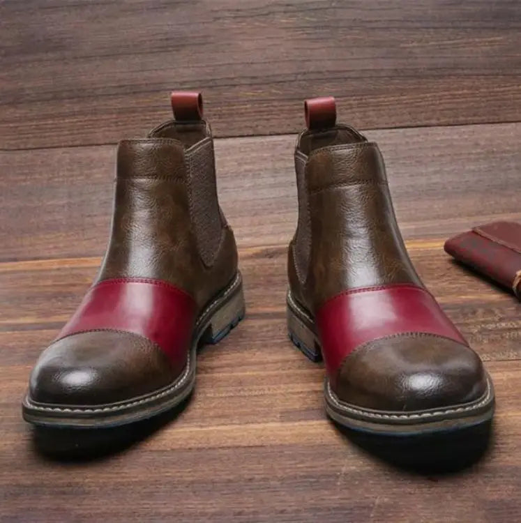 Men’s leather martin boots featuring brown and red two-tone leather chelsea style with a classic cap toe design and blue rubber sole.