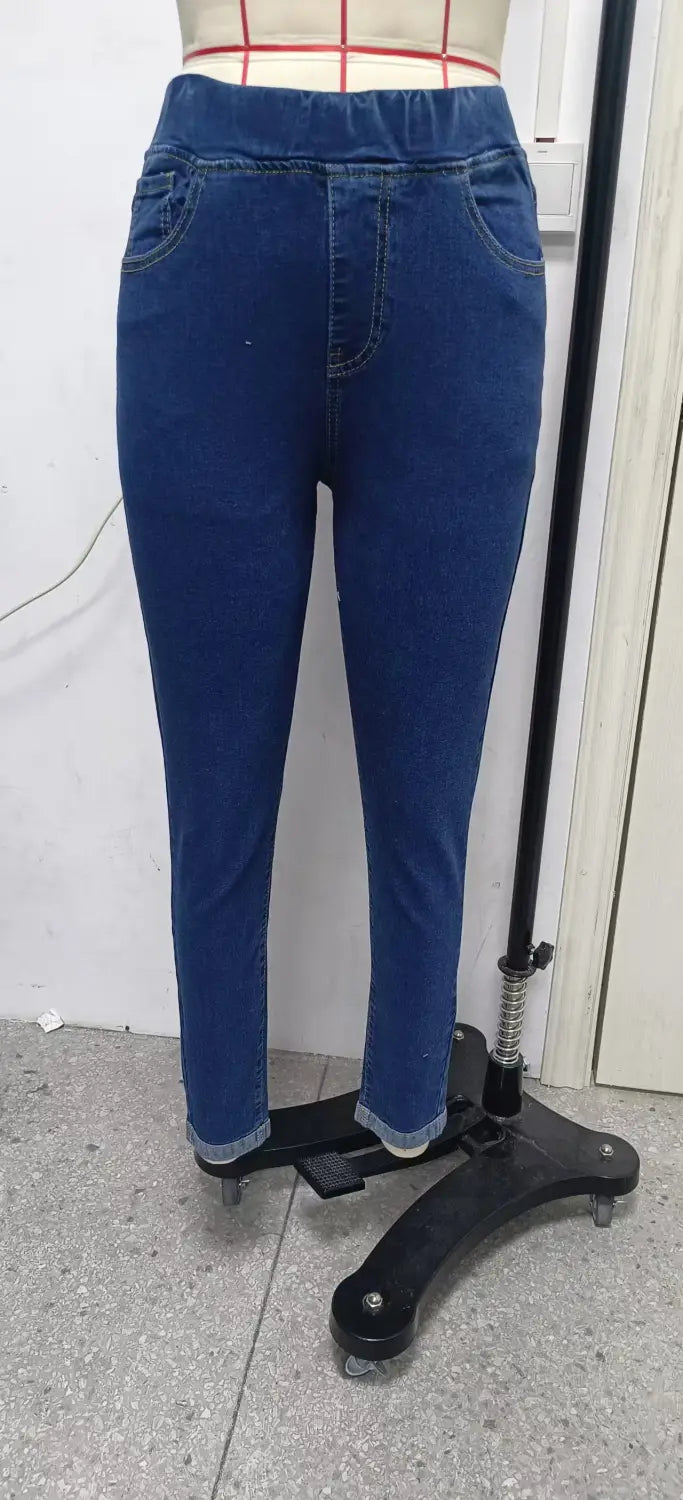 High waist slim denim leggings in blue denim with a slim fit design and rolled cuffs.