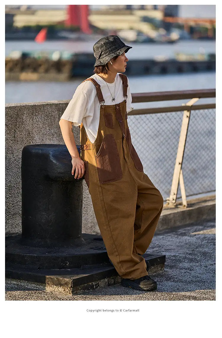 khaki retro suspender overalls made of brown canvas with reinforced brown leather patches on the pockets and waistband.