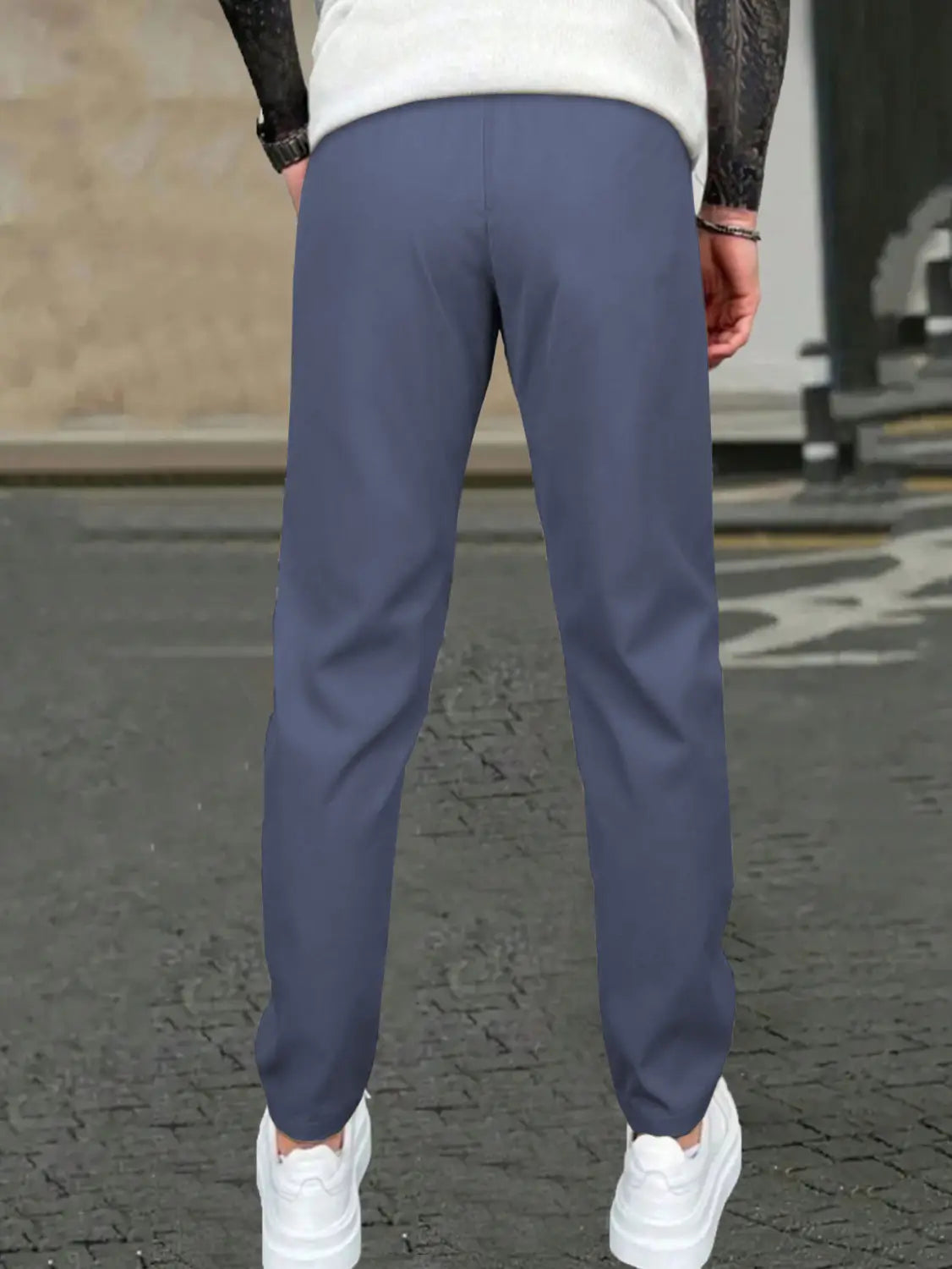 Blue slim fit tapered jogger pants with drawstring featuring smooth tailored fabric and clean stitching.