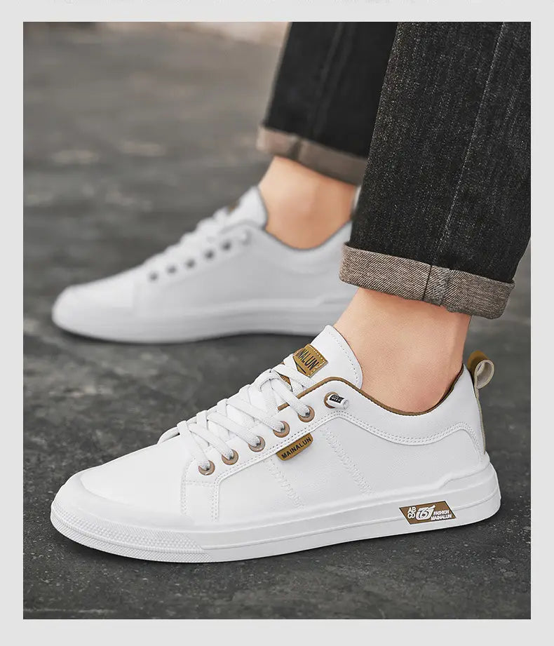 Men’s white minimalist leather casual sneakers with tan leather accents and branding patches on white canvas.