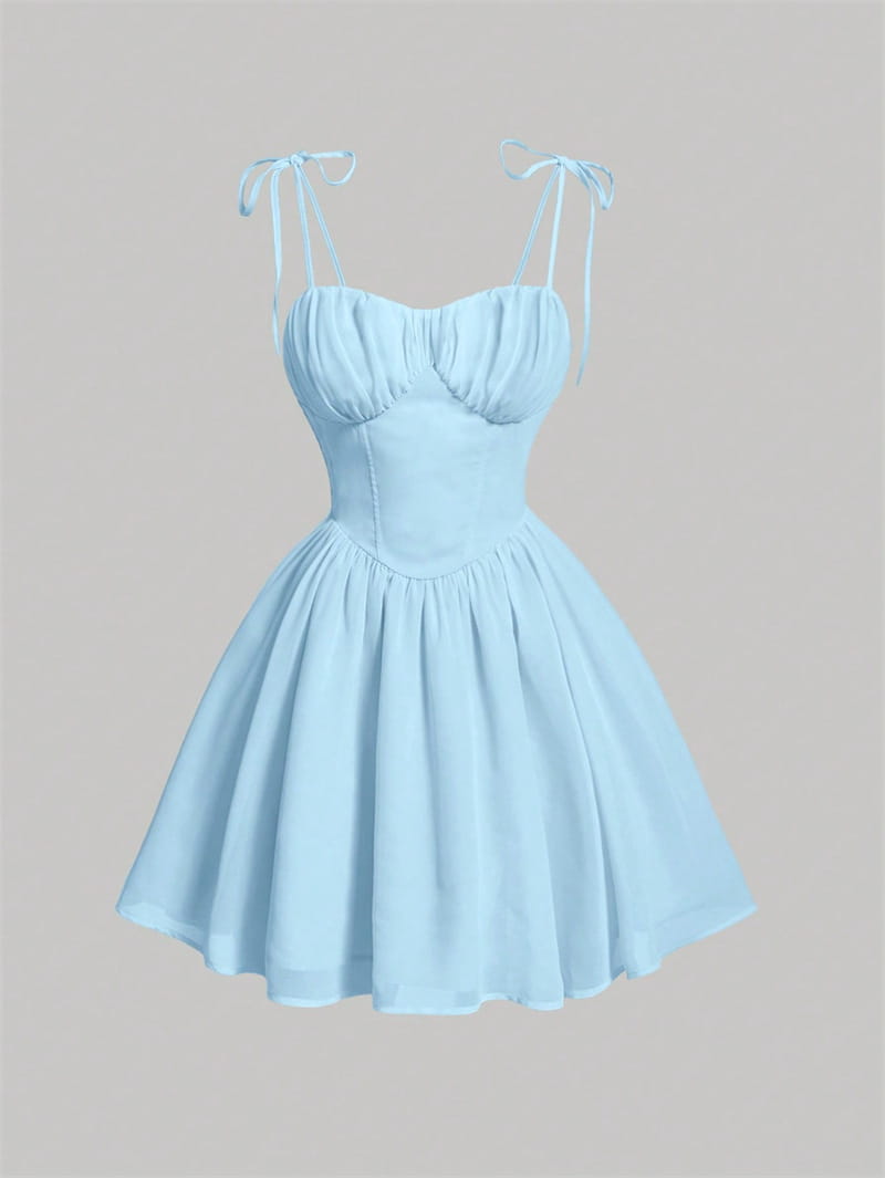 A soft pastel blue sky blue ruched corset mini dress with a fitted bodice, flowy fabric, and tied shoulder straps.