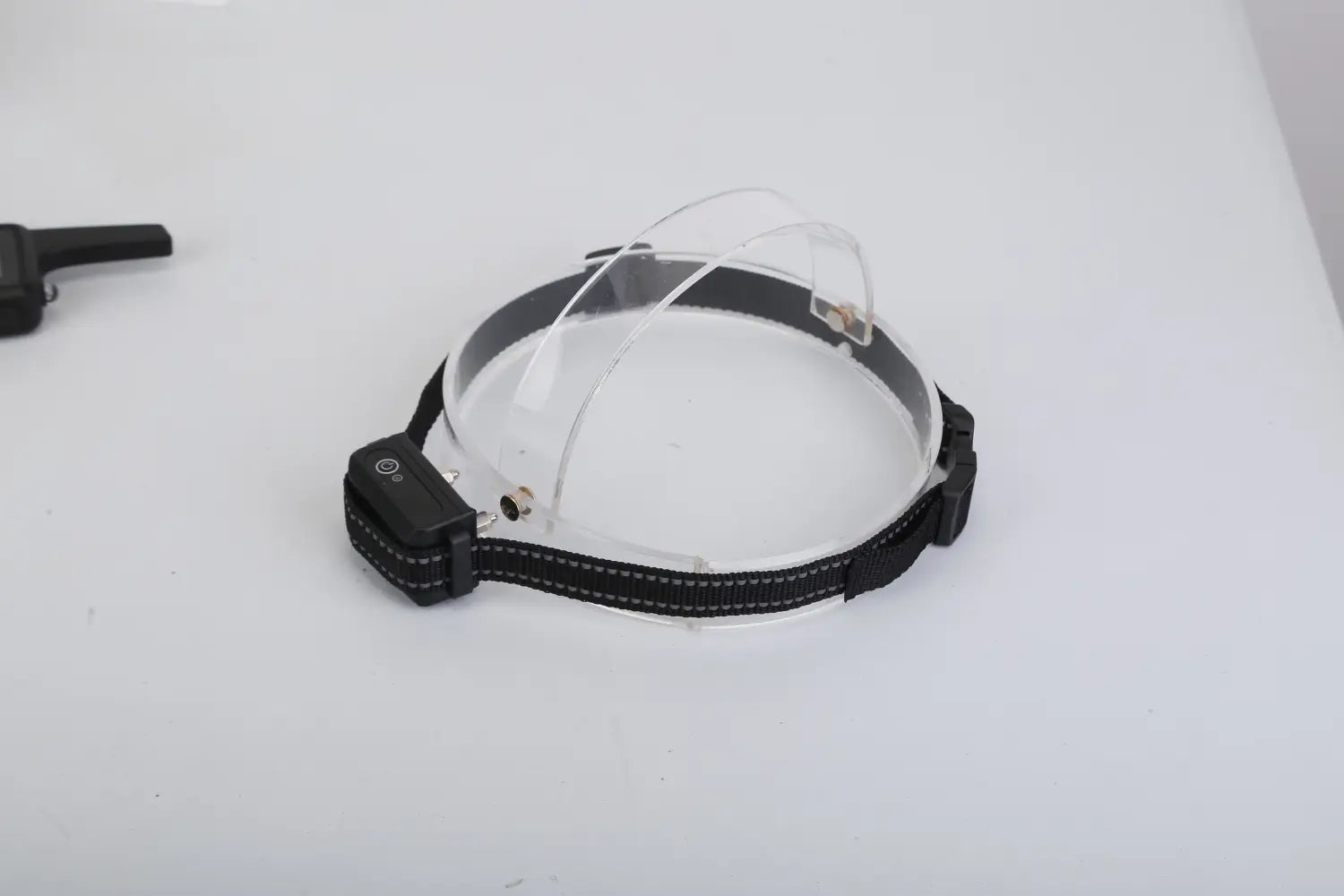 black dog training collar with 3280ft waterproof shock system featuring a headlamp with transparent visor and adjustable strap.