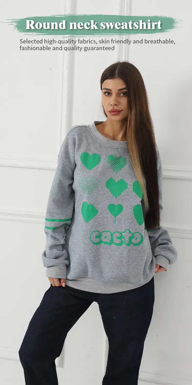 gray oversized round neck sweatshirt featuring a green heart and cacto graphic print suitable for casual wear