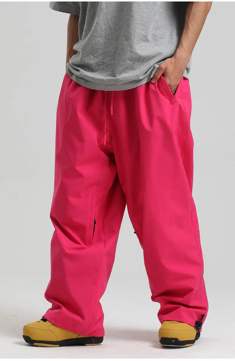 Bright pink waterproof windproof loose snow pants with a drawstring waist and zipper pockets designed for work and outdoor use.