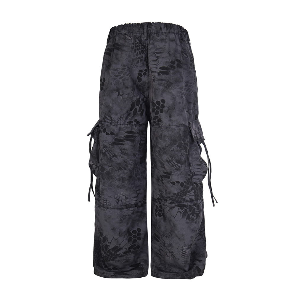 Black tactical cargo wide leg pants with dark gray camouflage pattern and multiple side pockets featuring drawstrings.