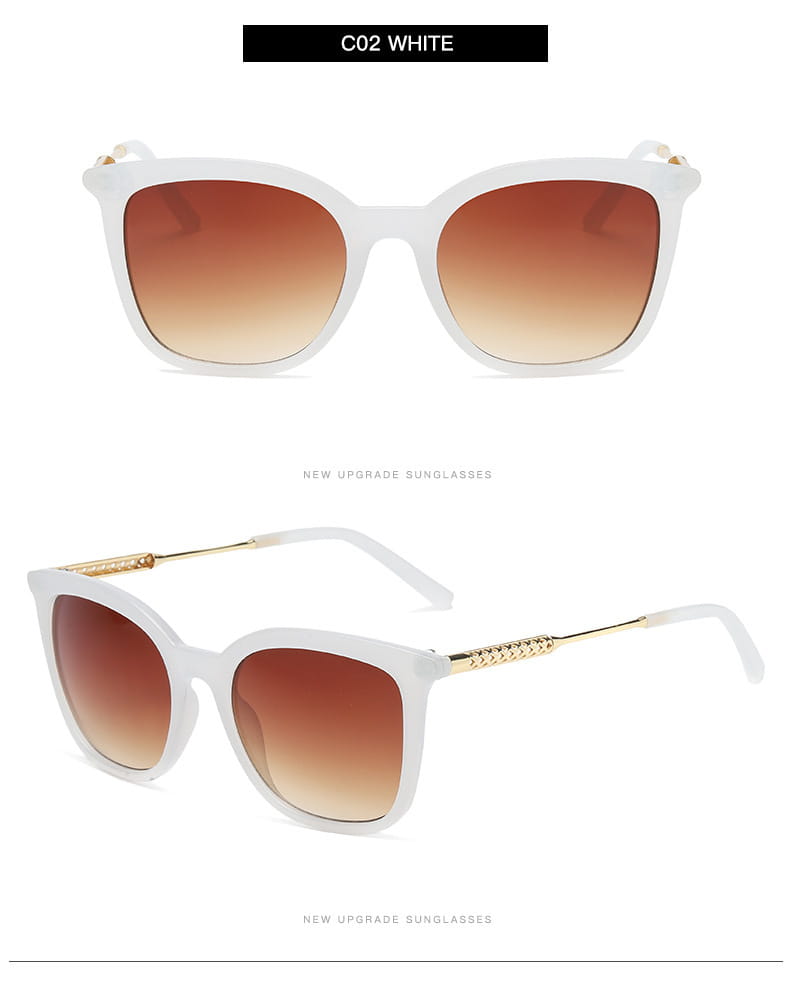 White vintage cat eye sunglasses with gradient brown lenses gold-tone temple accents and a gold chain detail.