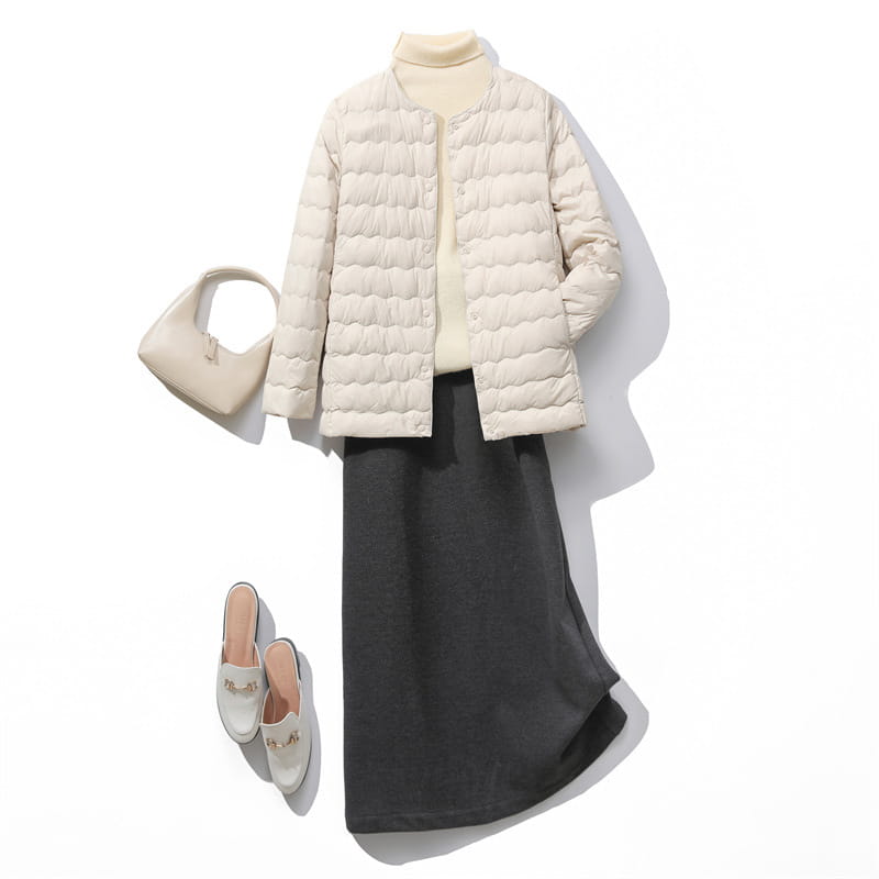 Cream-colored quilted puffer jacket with a high collar and button closure featured in the Puff Jacket Ruffled Crew Neck collection.