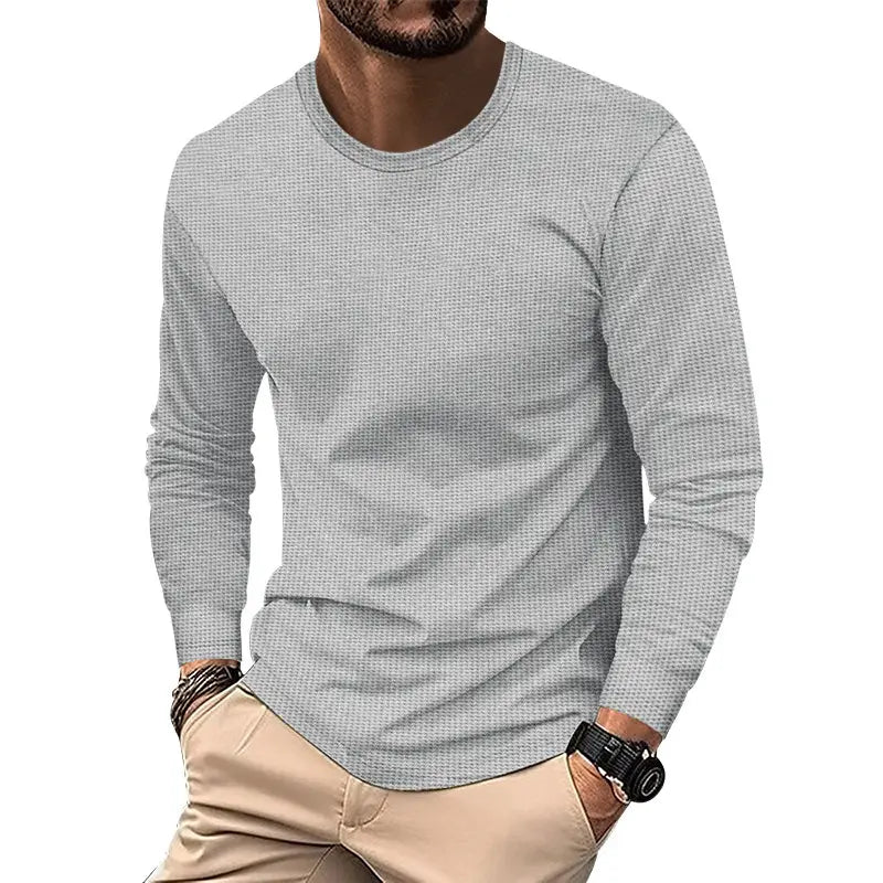 Gray men’s long sleeve waffle knit thermal pullover with a subtle textured weave and crew neck.