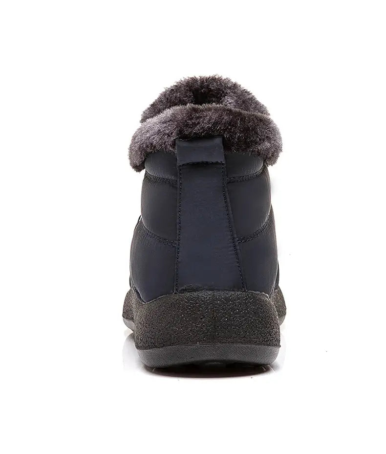 Botte d’hiver imperméable en neige bleu marine foncé, au design matelassé, avec doublure intérieure moelleuse en fausse fourrure grise et semelle en caoutchouc texturé pour une protection de la cheville.