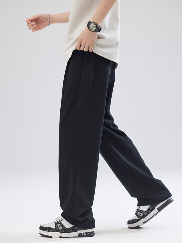 Pantalon pour hommes à plis, coupe ample à jambes larges et ajustement décontracté, couleur noir, avec une silhouette à coupe droite conçue pour le confort et le style.