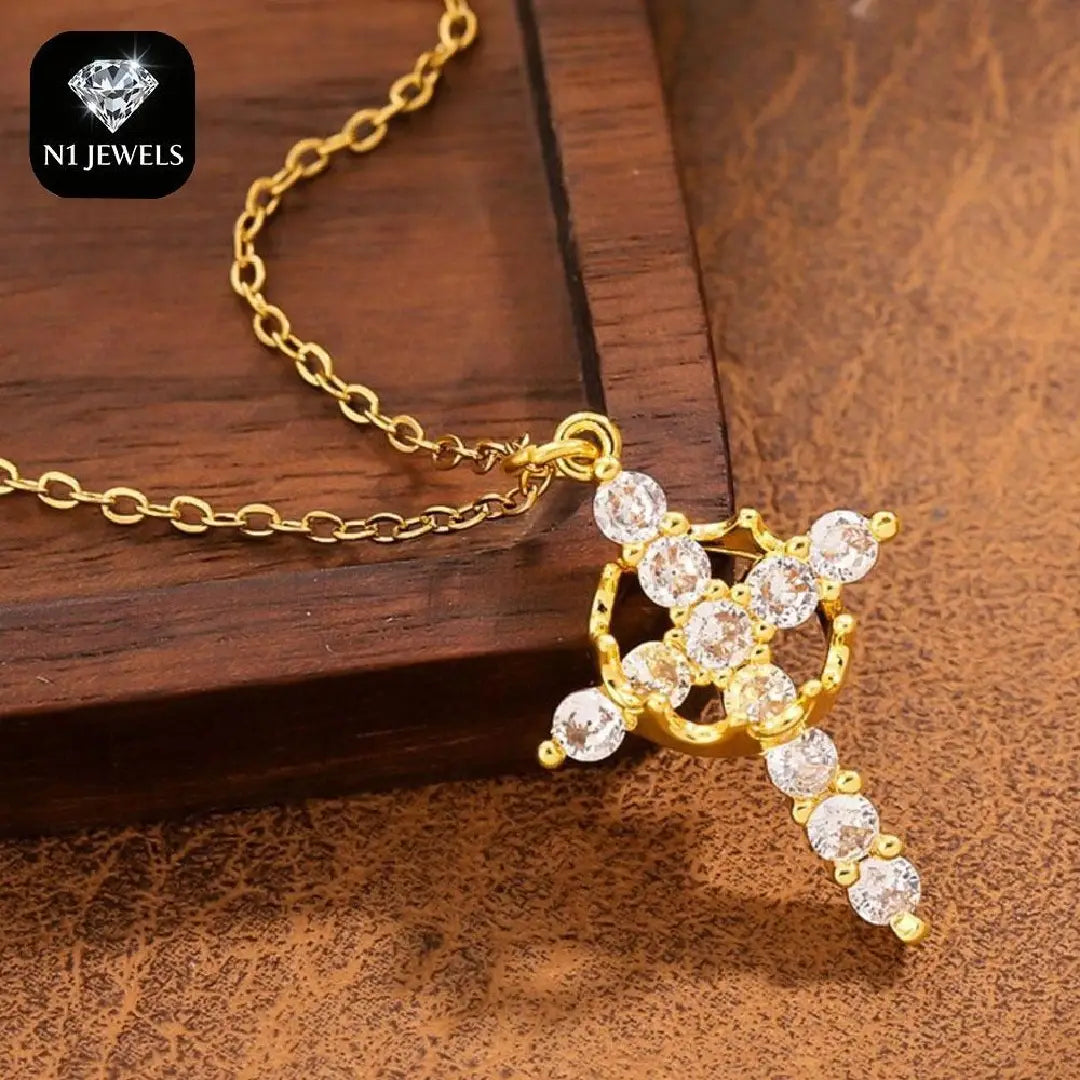 Gold cross pendant necklace adorned with clear sparkling cubic zirconia stones from the sparkling layered crown and cross pendant necklace collection