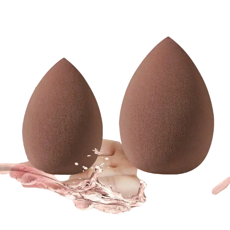 Brown teardrop-shaped makeup sponge with soft porous texture included in 33-piece set with nylon bristles brush material