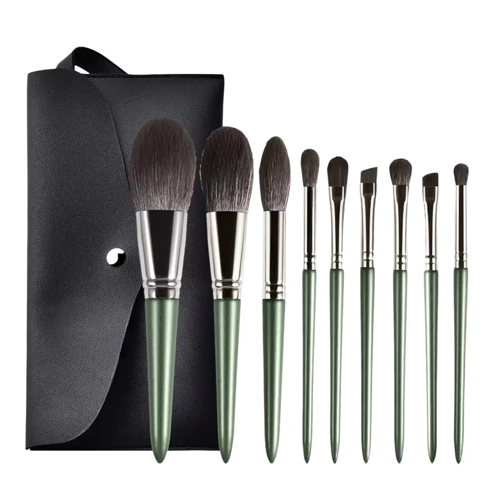 Set of nine olive green-handled makeup brushes with nylon bristle brush material beside a black leather case
