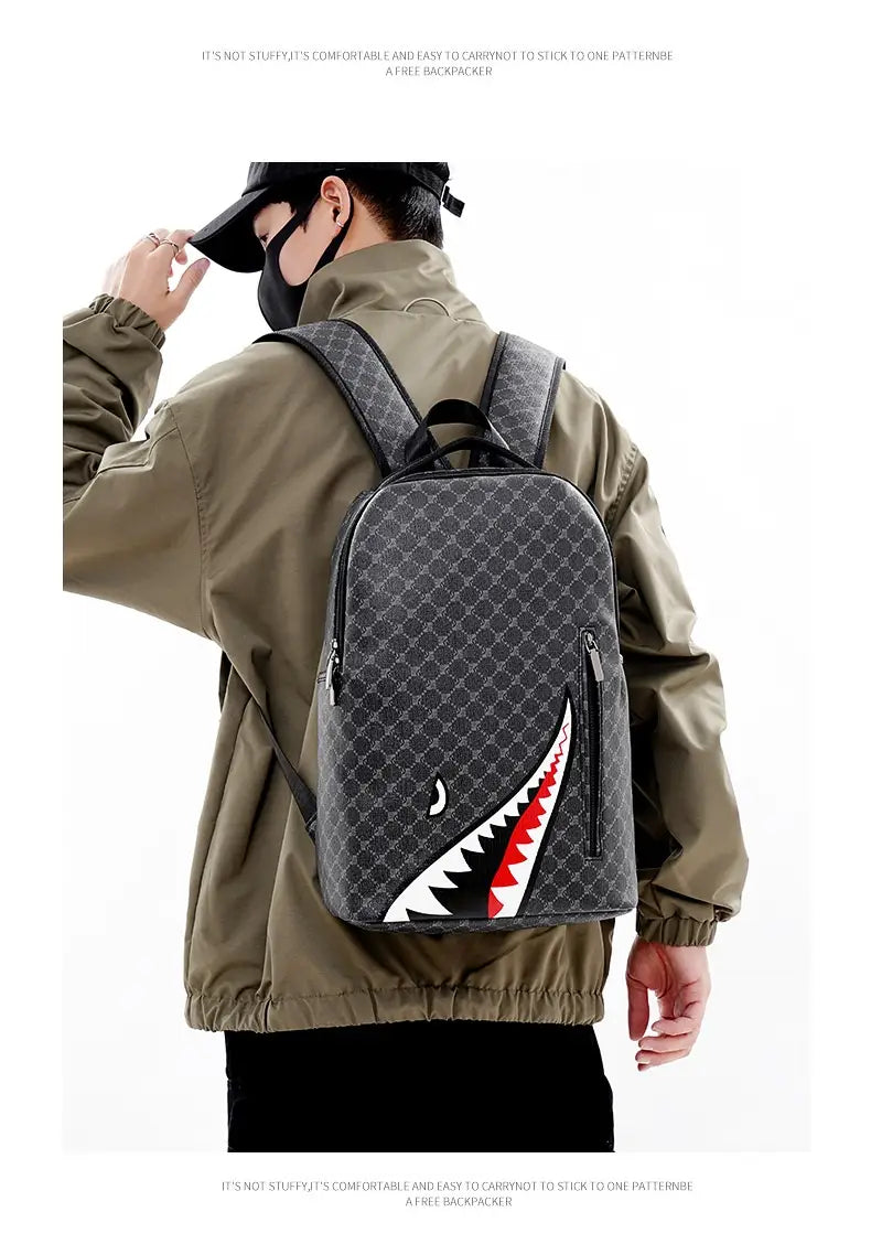 Gray backpack with large capacity featuring a repeating monogram pattern and a bold white red and black shark mouth design on the front made of geometric PU material for business use
