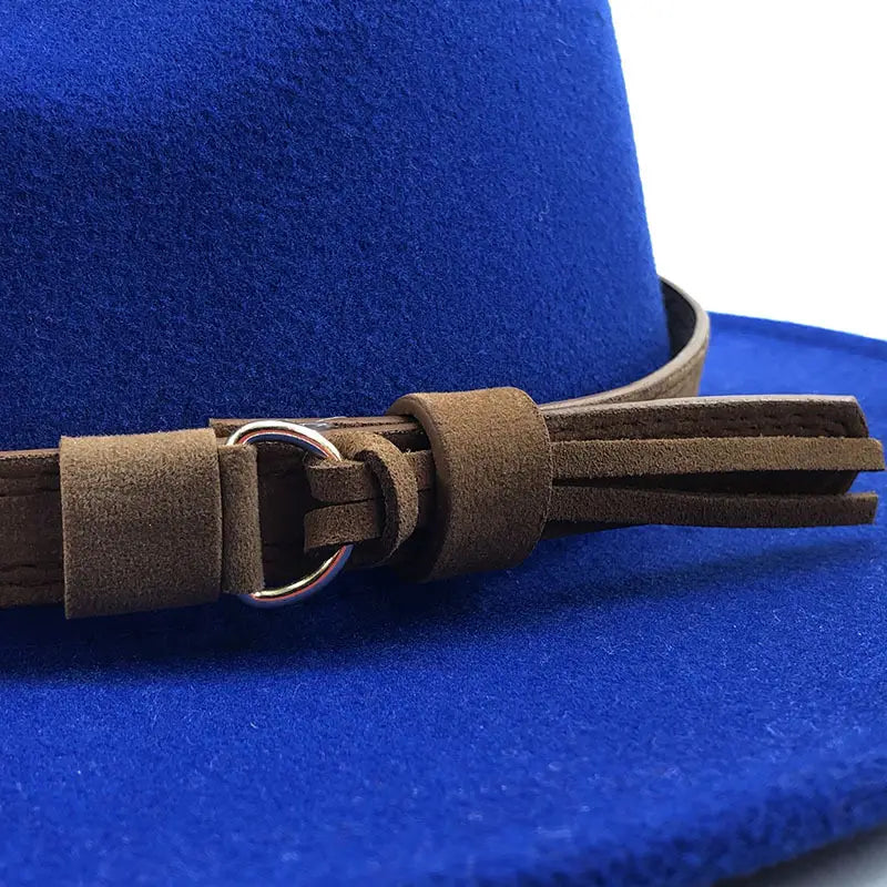 A rich royal blue wool fedora hat featuring a brown suede leather belt with a silver-toned buckle and decorative tassels.