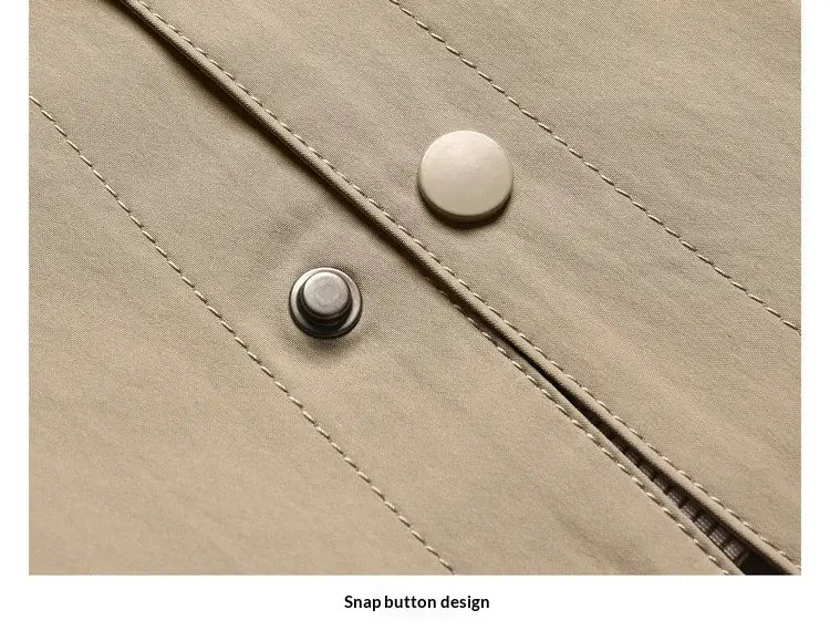 beige fabric of men lapel utility jacket with checkered lining featuring one round white plastic button and one metallic silver snap button.