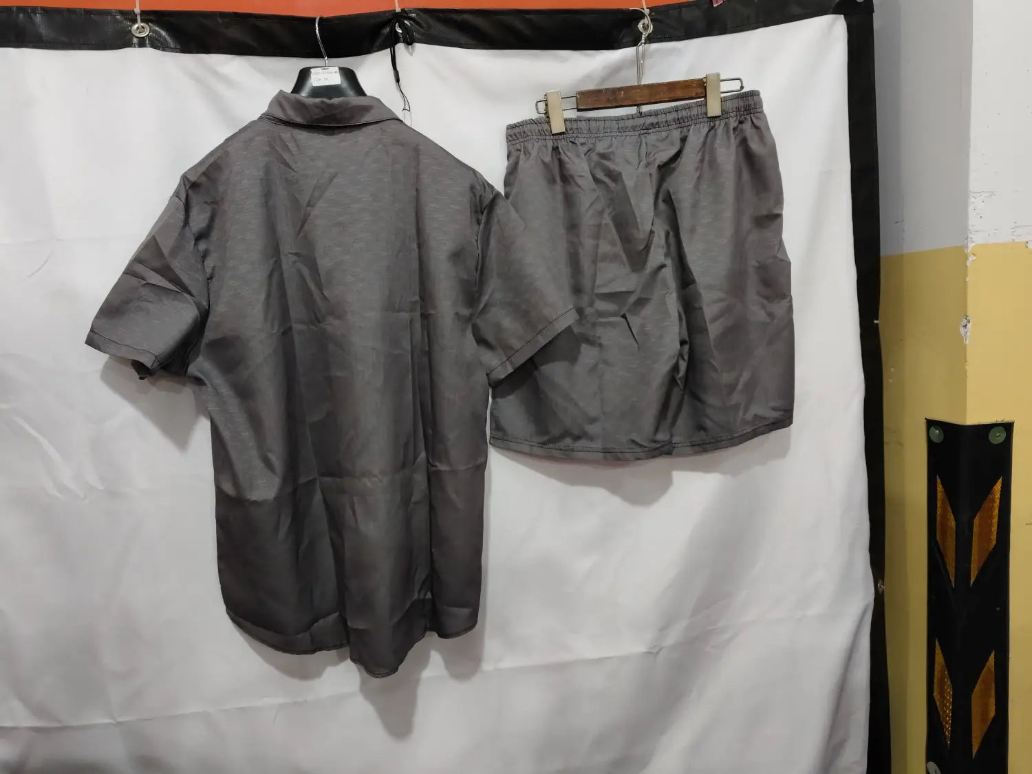 chemise en lin grise boutonnée et ensemble de shorts assortis, en tissu léger, avec taille élastique pour une tenue décontractée pour homme.
