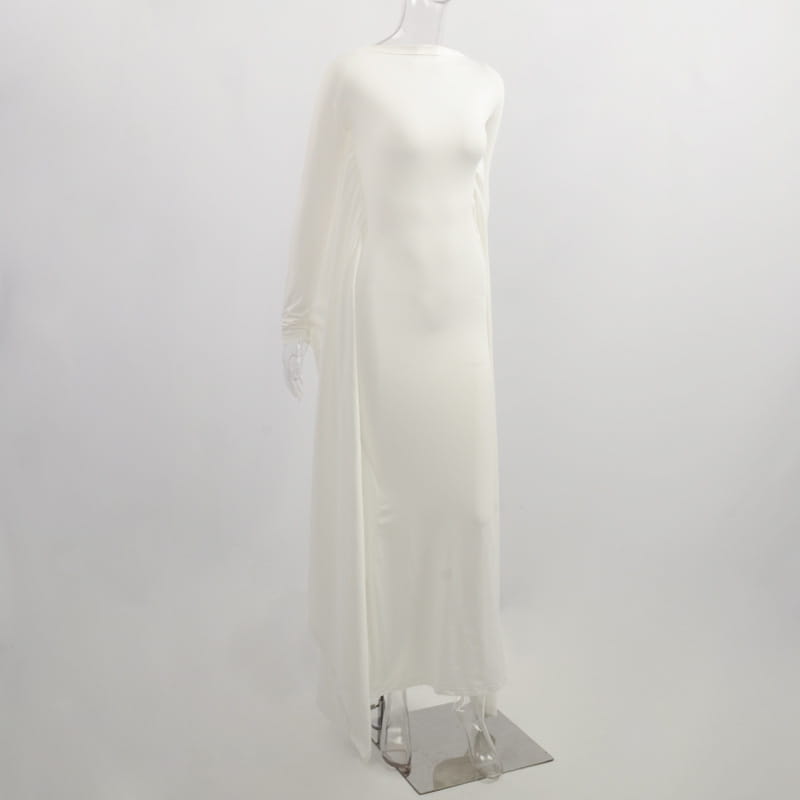 A flowing off-white sheer maxi dress with long asymmetrical satin batwing sleeves and a high neckline.