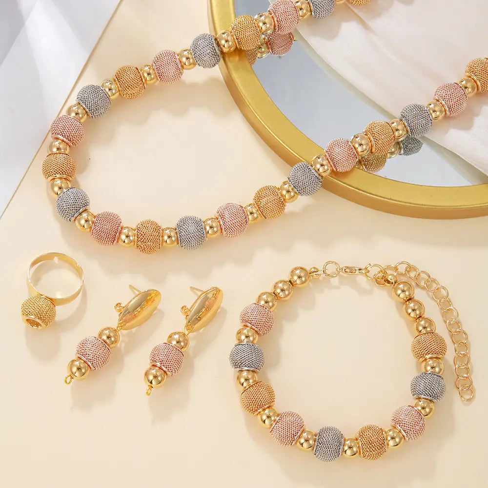 Gold-toned and rose gold beaded necklace with textured spherical beads in a tri-color pattern of gold rose gold and silver from the 5-piece tri-tone metallic beaded jewelry set.