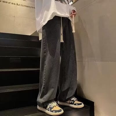 Dark gray wide-leg denim pants with a relaxed fit and visible stitching details featured as corduroy drawstring casual trousers.