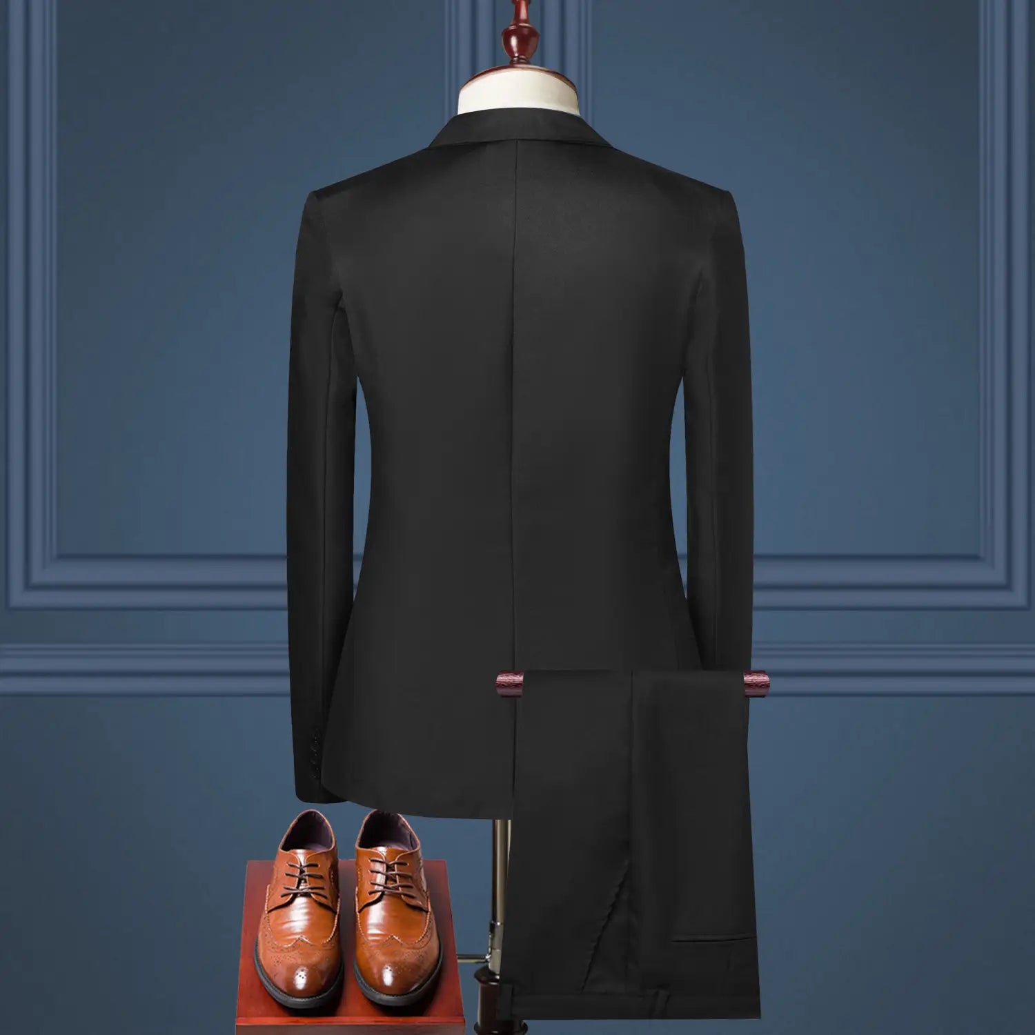 Black tailored suit jacket featuring a sleek fit and classic design displayed on a mannequin for men solid color two piece leisure suit.