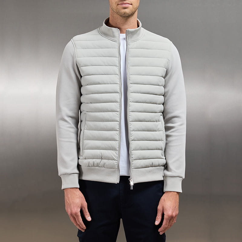 Light gray quilted lightweight men’s bomber jacket with stand collar and full-length zipper.