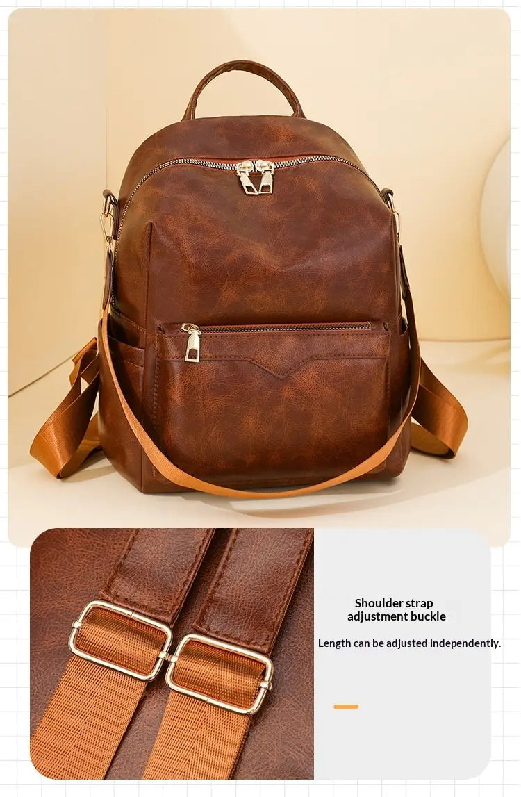Brown faux leather women’s large capacity commuter backpack with adjustable shoulder straps and silver-toned zippers.