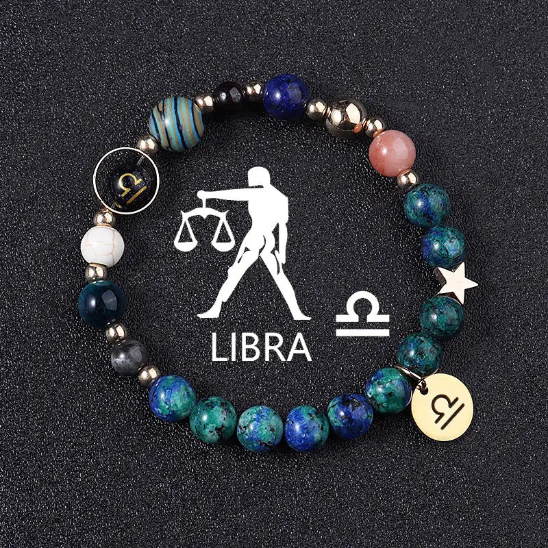 A natural stone zodiac constellation beaded bracelet featuring blue green and pink stones with metallic accents and Libra zodiac charm pendants.