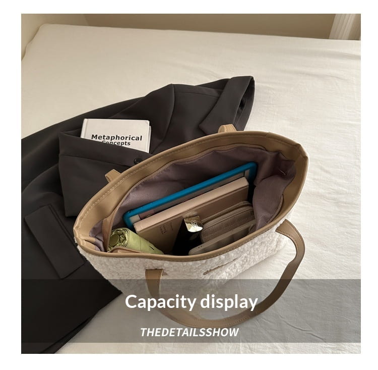 Brown faux fur tote bag with beige textured body, tan leather handles, and spacious interior lining suitable for daily use.