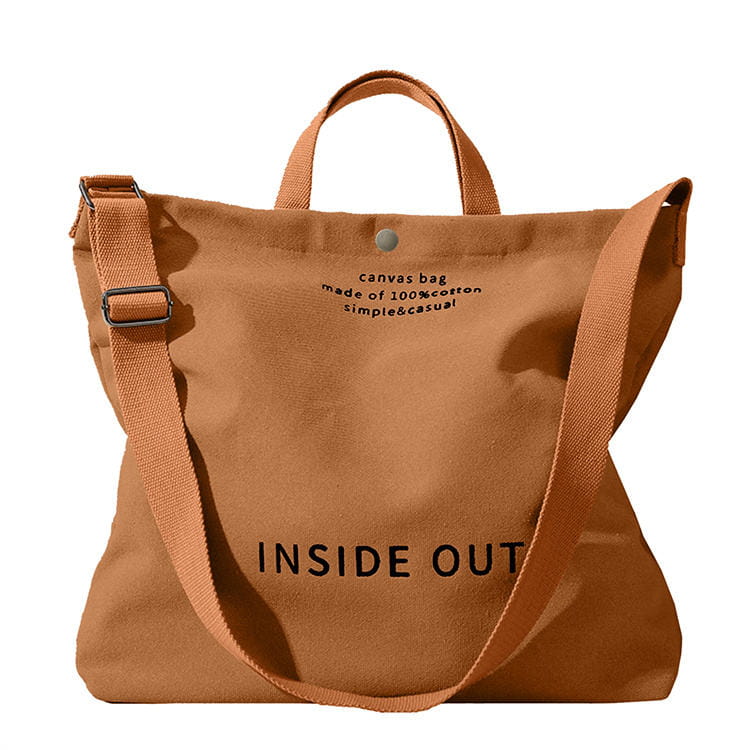 Tan canvas tote bag with high end large capacity black inside out lettering and wooden ring handles.