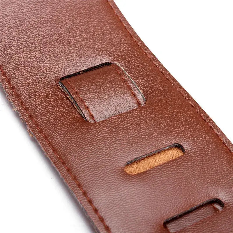 brown leather guitar strap with stitched edges suede lining and adjustable holes measuring 110 to 130 centimeters