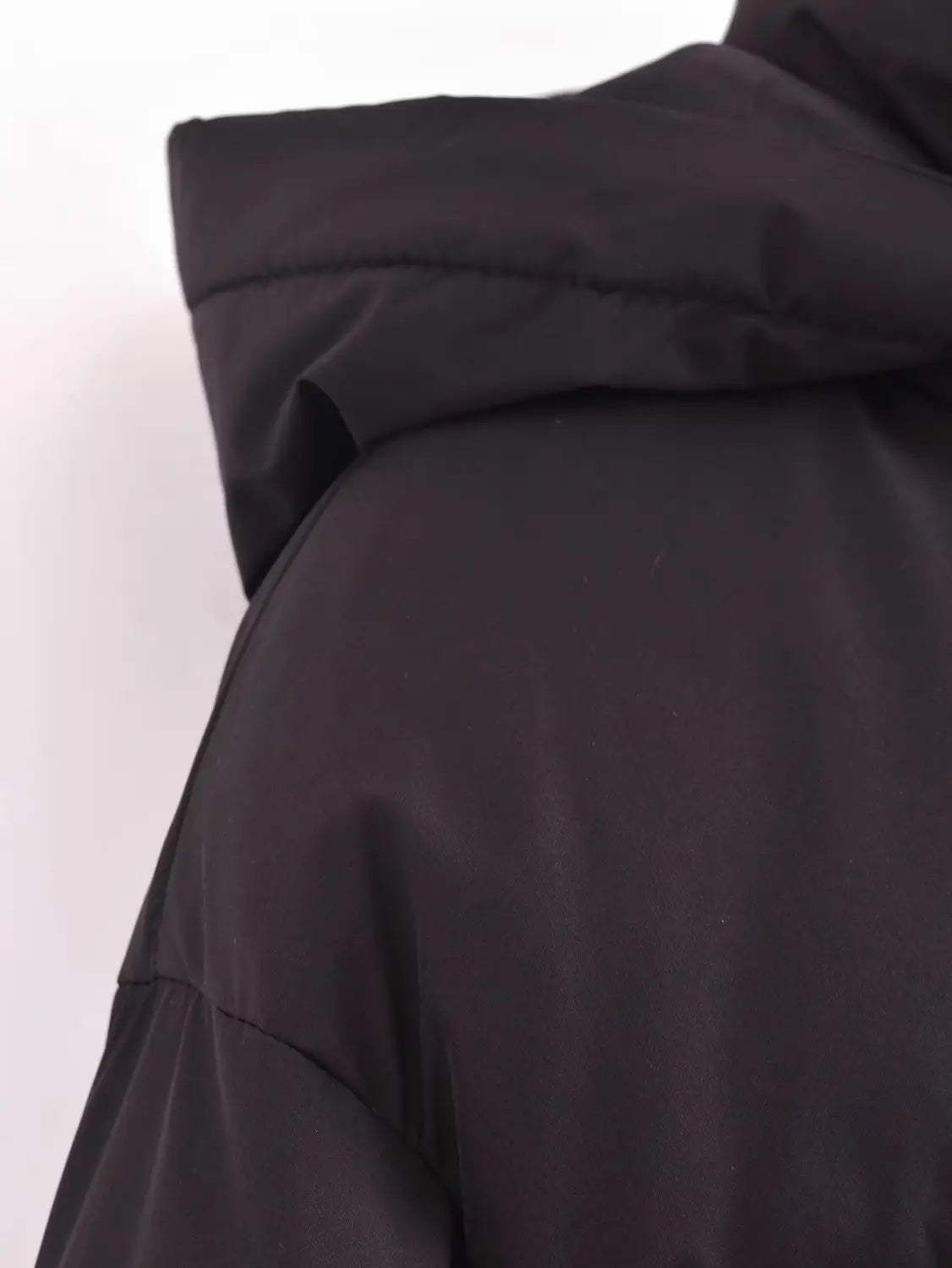 Black quilted hooded puffer coat with a smooth water-resistant fabric and a quilted hood.