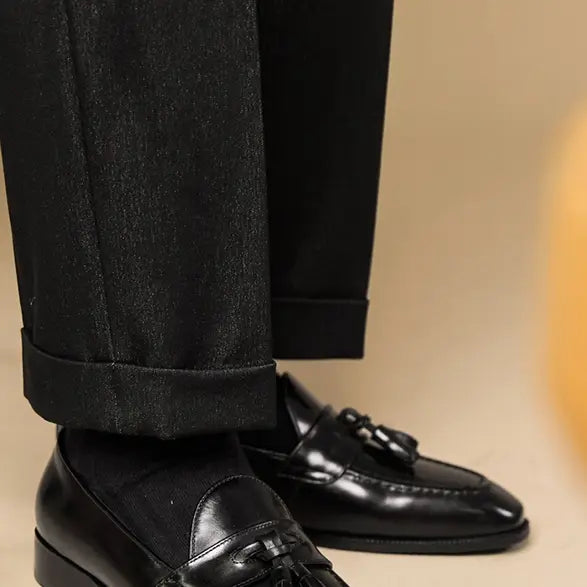 polished genuine leather tassel loafers in black patent leather with a glossy finish and classic design