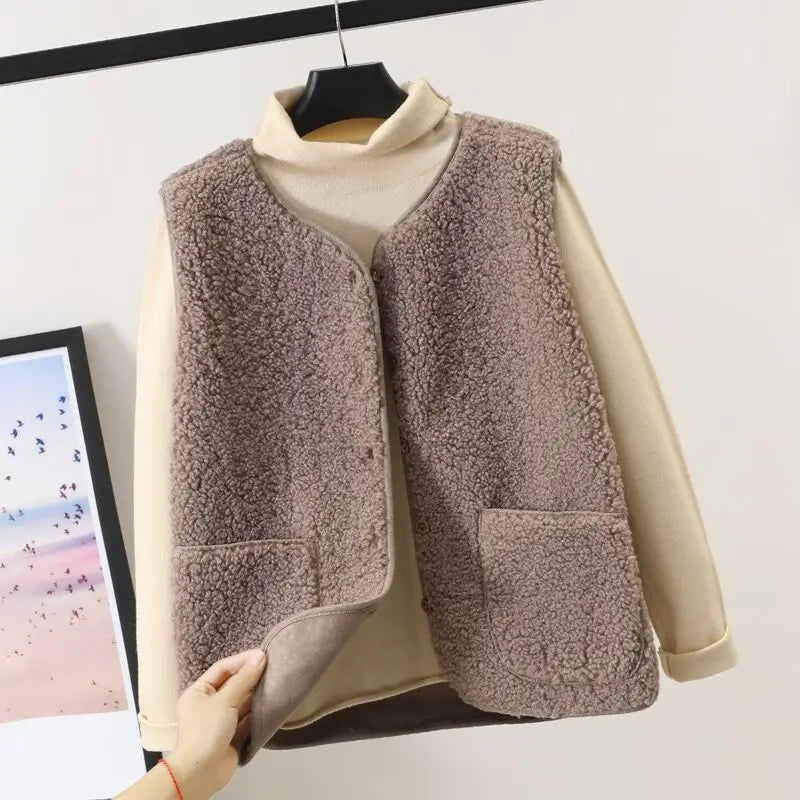 A cozy beige shearling fleece vest for women featuring a soft textured exterior and matching inner lining designed for winter outerwear.
