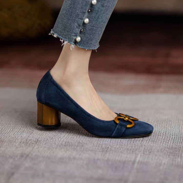 Navy blue suede square toe leather pumps with a gold-toned metal buckle detail and polished wooden heel.