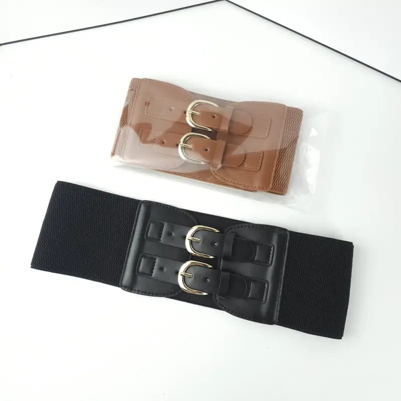 Women elastic waist belt in black with dual silver-toned buckle closure and faux leather trim.