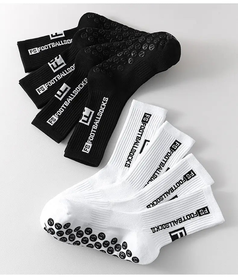 Black and white anti slip football grip socks for men with textured grip dots on the soles ribbed cuff and fs football socks branding.