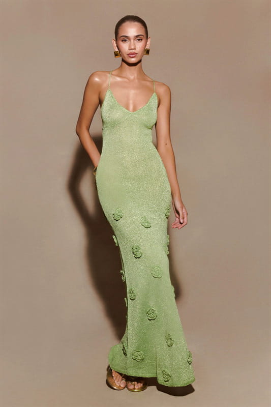 A sleek light green crochet floral lace mermaid maxi dress with delicate floral appliqués along the skirt and glitter accents.