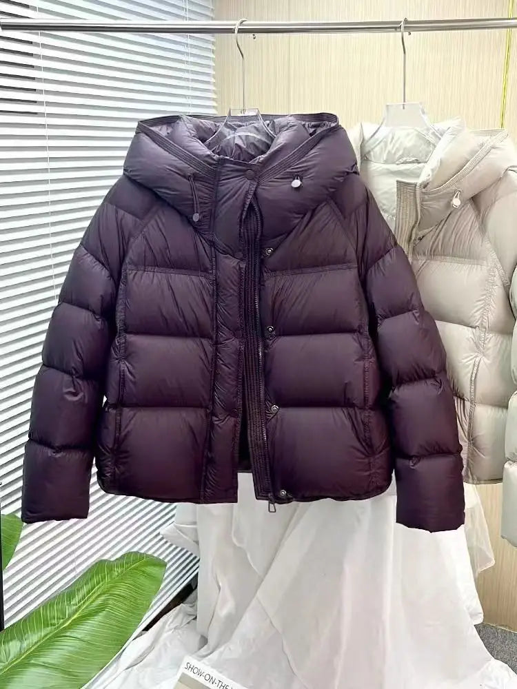 dark purple quilted down puffer jacket with a hood and front zipper designed as a loose hooded winter coat.