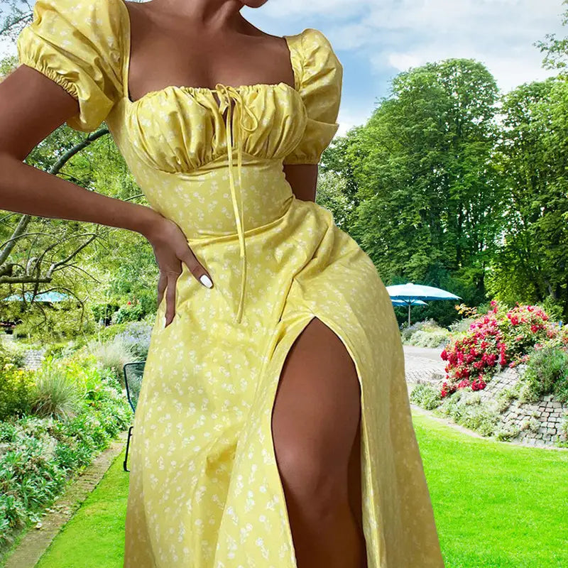 A vibrant yellow floral square neck puff sleeve midi slit dress with a subtle white floral pattern and puffy short sleeves.
